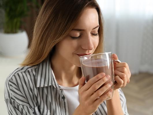 Girl drinking cacao.