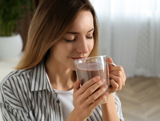 Girl drinking cacao.